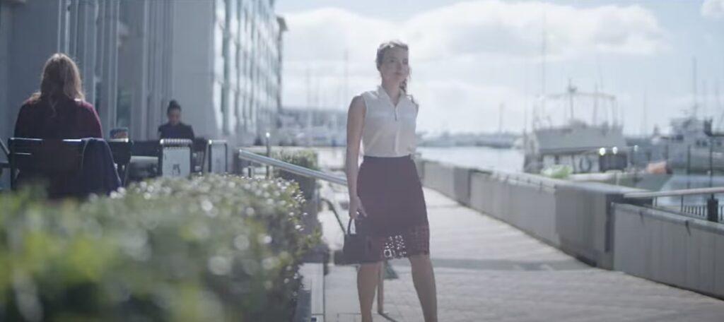 Woman walking outdoors near the marina.